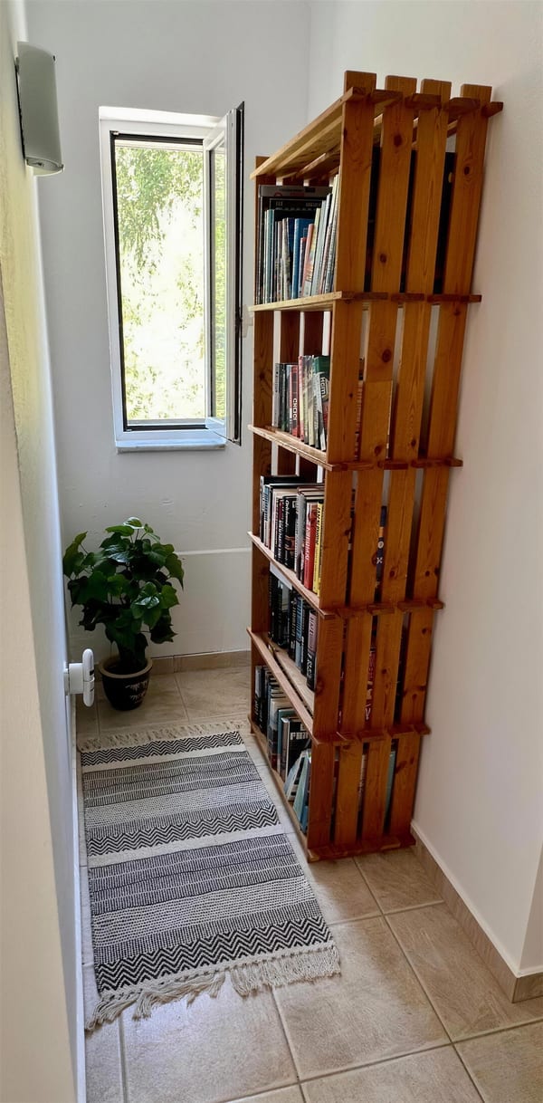 Books and plants beside the villa staircase