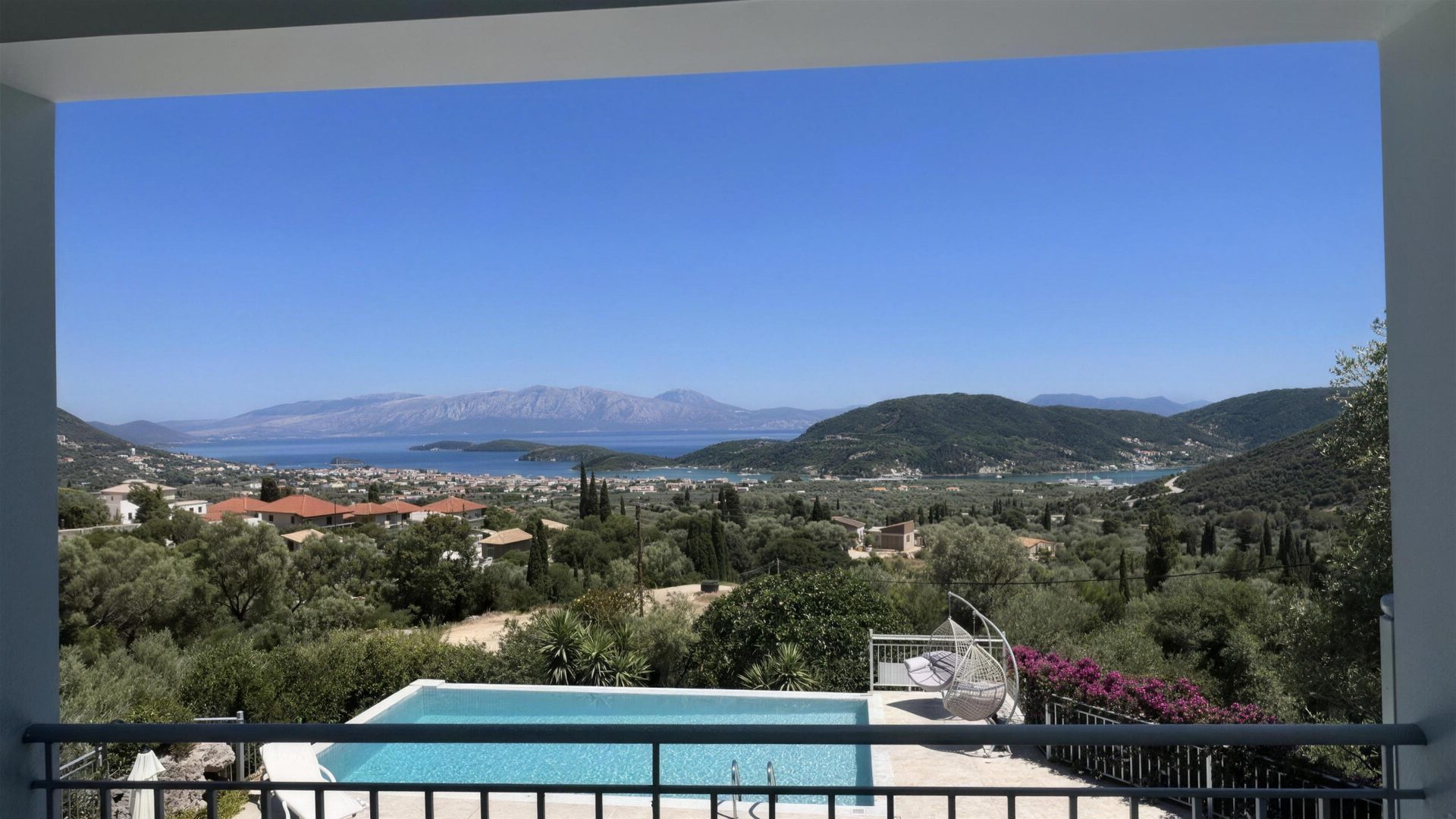 The pool and terrace from above, olive terraces falling away to the water
