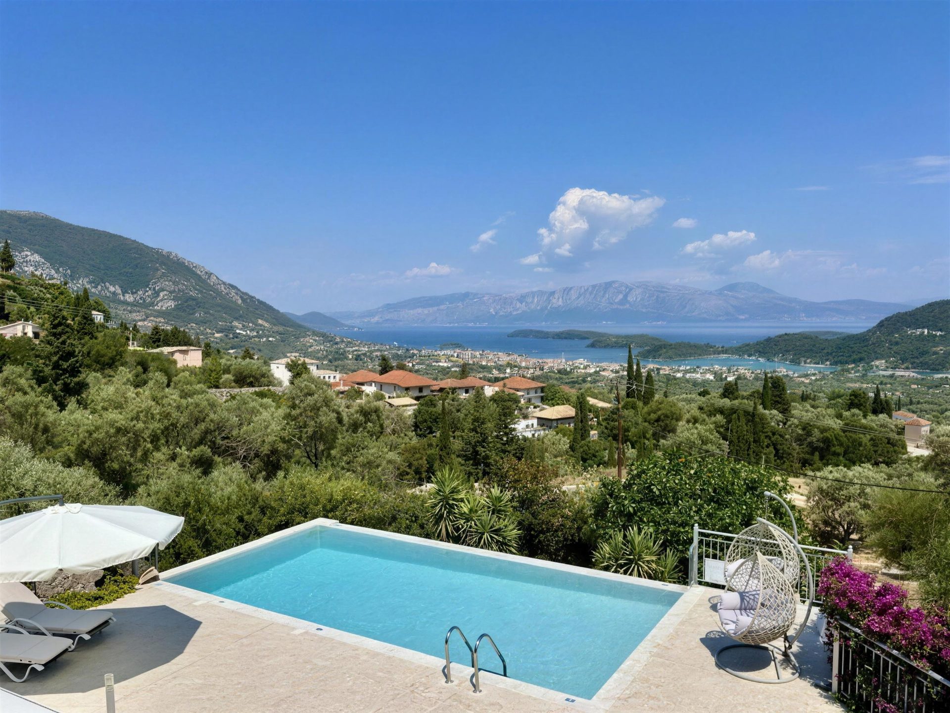 The pool on the front terrace, the whole of Nidri Bay and the mountains beyond