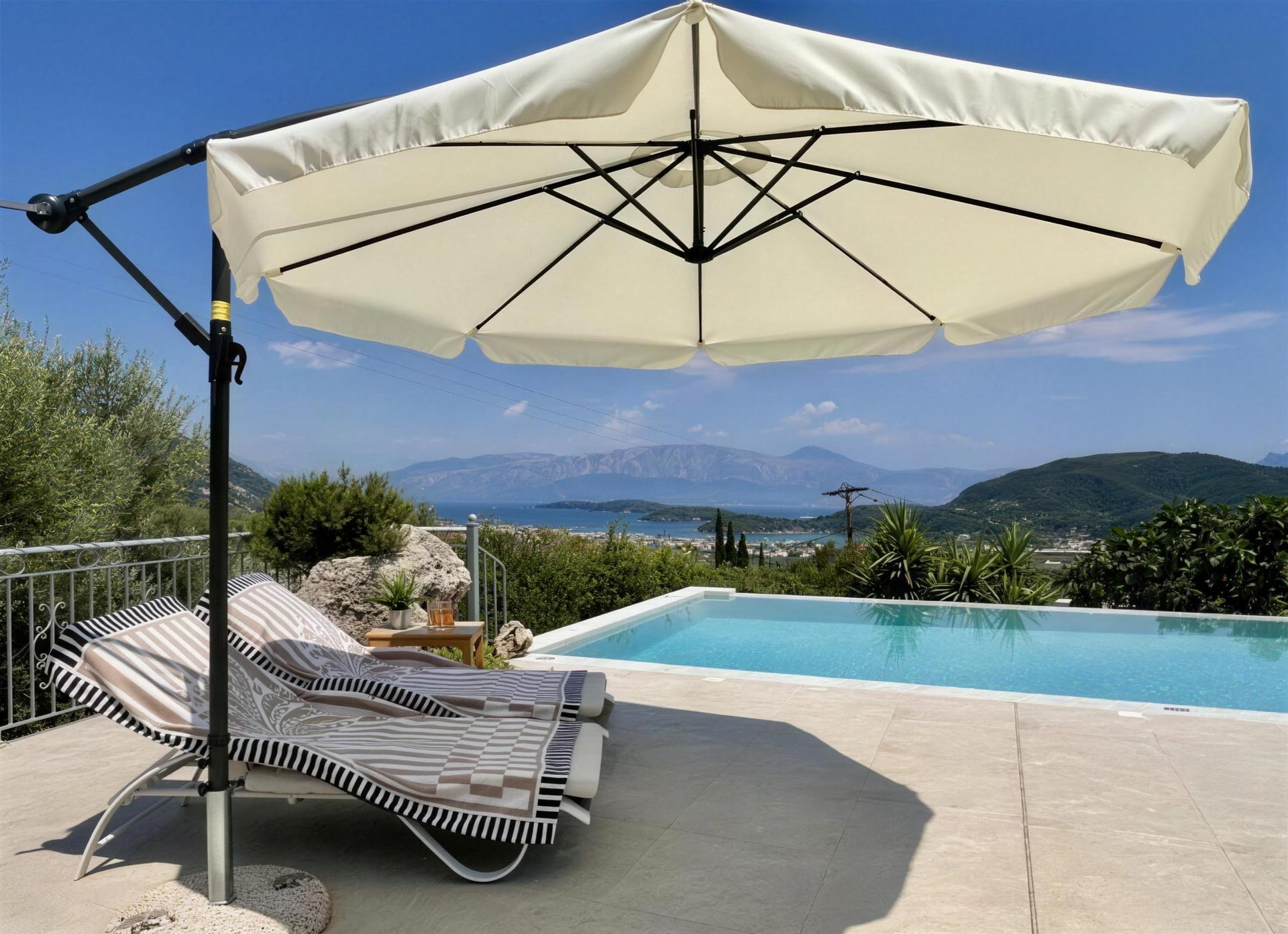 Sunbeds and a cantilever parasol on the tiled terrace beside the pool